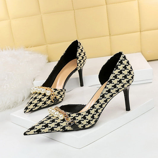 Pointed-toe pumps with houndstooth design and embellished pearl accents